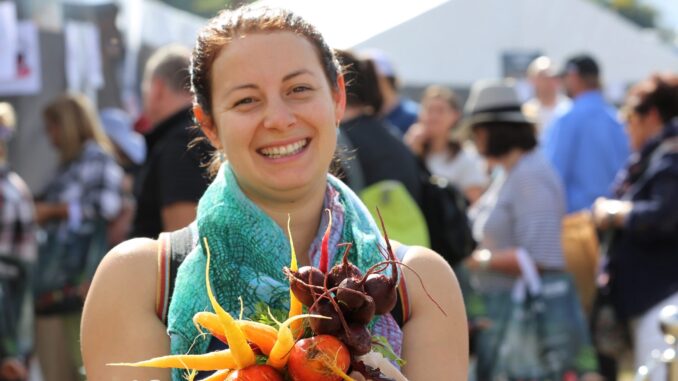 Cassie Reed of Tamborine Village with rainbow carrots from Valley Pride Produce. Photo by Susie Cunningham.