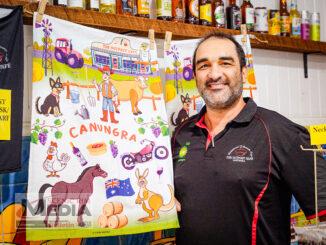 Andrew Covino with the new Canungra themed tea towels. Photo by Katherine O'Brien.