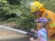 Phil Rankin, Beechmont RFS Third Officer shows Mahina Folwer how to use the fire hose